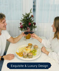 Two people toasting over a meal with a Mother Of Pearl Turntable Organizer Lazy Susan on the table, featuring snacks.