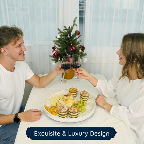 Two people toasting over a meal with a Mother Of Pearl Turntable Organizer Lazy Susan on the table, featuring snacks.
