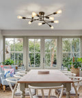 Black Semi Flush Mount Ceiling Light Fixture With 9 Lights in modern dining room with large windows and wooden table