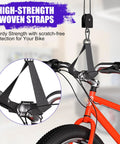 2 Pack Heavy Duty Bike Hoist Pulley System For Garage Ceiling Storage with high-strength woven straps lifting a red bike.