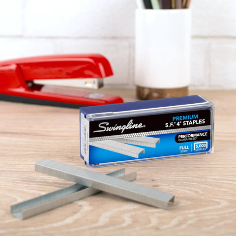 Premium One Quarter Inch Staples, 210 Per Strip, Five Pack, 5000 Per Box displayed with red stapler on desk