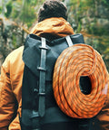 Hiker with a black backpack carrying 9/16 Inch Double Braid Polyester Rope 200 Ft Heavy Duty Pulling Line For Towing And Rigging