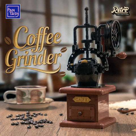 Front view of Vintage Hand Crank Coffee Grinder Building Blocks Set With Moving Gears on a table with coffee beans and cup.