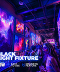 10W 1Ft Magnetic UV Blacklight LED Strip Kit illuminating fluorescent posters in a lit glow party setting, vibrant colors displayed.