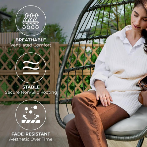 Woman relaxing on a Hanging Egg Chair With Stand for Indoor Outdoor Chill, Plush Washable Cushions; shows comfort features.