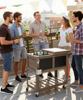 80 Qt Rolling Patio Cooler With Bottle Opener And Shelf For Backyard Hangouts And Gatherings, standing on a patio with group