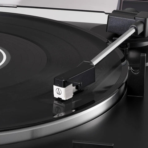 Close-up view of the Audio-Technica At-Lp60X-Bk Fully Automatic Belt Drive Stereo Turntable Black with tonearm on vinyl.