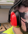 Person wearing Adjustable Safety Ear Muffs Hearing Protection NRR 26 dB Universal Fit For Gun Hunting Shooting Construction