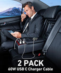 Two-pack white USB-A to USB-C car charging cables, 3 ft, in a car with a man in a suit using a smartphone.