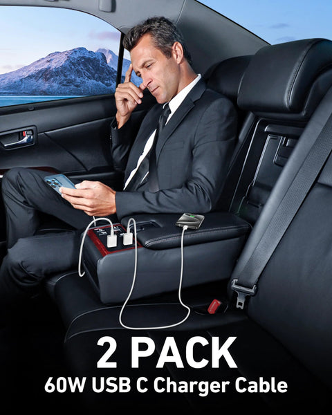 Two-pack white USB-A to USB-C car charging cables, 3 ft, in a car with a man in a suit using a smartphone.
