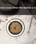 Kitchen Sink Strainer 3.25 Inch Anti Clog Food Catcher in action, water flowing easily with full basket, Gray Rimless Design.