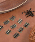12 Pcs Small Butterfly Hinges Antique Bronze Mini Metal Hinges 20 x 17mm For DIY Wooden Jewelry Boxes Cabinets Crafts With 48 Tiny Screws Durable Iron Construction displayed on leather surface