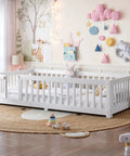 Totally Built Tough Twin Floor Bed With Montessori Design And Complete Safety Guardrails Plus Easy Access Door For Kids, Solid Wood Low Profile Slatted Frame In Fresh White in a bright nursery setting.