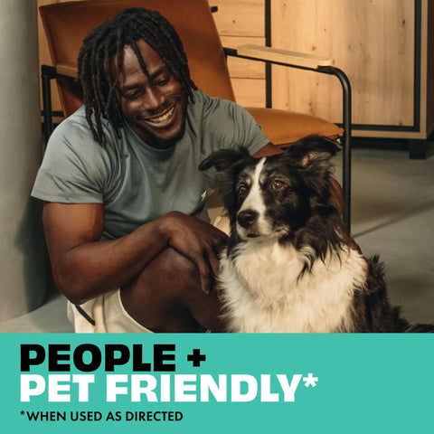 Man sitting next to a black and white dog indoors with the text 'People + Pet Friendly' displayed.