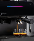 Next Level Semi Automatic Espresso Machine With Built In Grinder Steam Frother Featuring Italian Made 15 Bar Pump For Straight Up Perfect Shots Plus Wifi Connected Custom Brewing In Slick Black brewing espresso into two glasses.