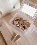 Hella Sturdy Oak Wood Plug Set For Screw Holes Odorless Reusable Pocket Hole Inserts With Sandable Finish No Fuss Diy Wood Filler Plugs Bulk Pack Of Fifty inside a clear container near wooden surface.