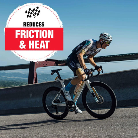 Cyclist riding on a road bike with a banner reading 'Reduces Friction & Heat', showcasing Ceramic Bike Grease For Bottom Brackets, Hubs, And Headsets, Advanced Nonstick Ceramic Lubricant Reducing Friction, Heat, And Wear, Waterproof Rust Protection, 2oz Tube For Smoother Shifts And Longer Bearing Life.