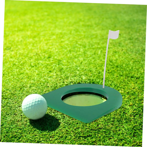 Golf ball near green putting cup with flag from 2 Pack Portable Golf Putting Cup Practice Set With Continuous Ball Return For Indoor Training And Travel