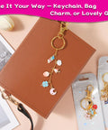 All In One Lip Gloss Keychain Making Kit with 100 Enamel Charms shown with beaded keychain on a brown notebook
