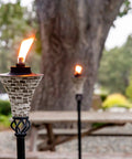Easy Pour Mosaic Torch For Outdoor Vibes, Gray Ceramic Tile Torch With Weather Resistant Steel in garden setting