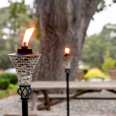 Easy Pour Mosaic Torch For Outdoor Vibes, Gray Ceramic Tile Torch With Weather Resistant Steel in garden setting