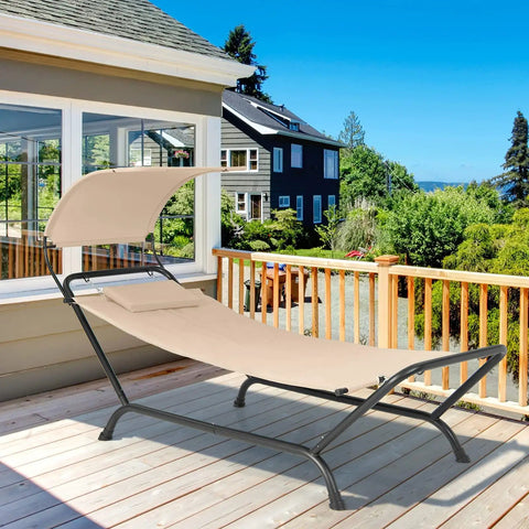 Beige Hanging Hammock Chair With Stand And Canopy for Patio Chillin Cushions and Pillow Included on a sunny porch.