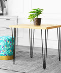 Table with wood top featuring 25.5 Inch Hairpin Leg Set of 4, Heavy Duty Steel Table Legs With Free Screws, in a modern setting.