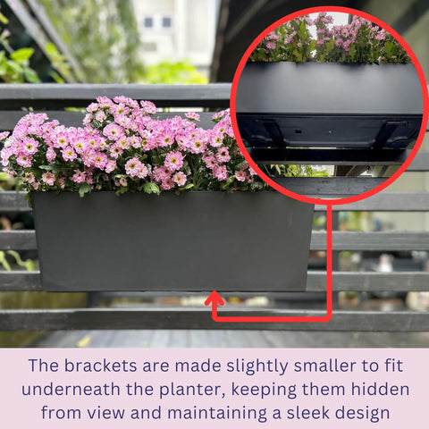 Super Sleek Two Pack Rail Planters For Balcony And Deck Twenty Inch Self Watering Garden Boxes In Matte Black with pink flowers.