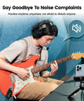 Person using Mighty Plug Pro MP3 Guitar And Bass Headphone Amp With Built In Effects for silent practice with red guitar