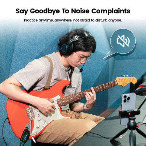 Person using Mighty Plug Pro MP3 Guitar And Bass Headphone Amp With Built In Effects for silent practice with red guitar