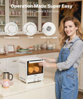 User operates 13Quart Sublimation Oven for 20Oz Tumblers with easy controls in a cozy kitchen setting.