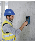 Man using Hardcore Stud Finder Wall Scanner Boasting Dead On Rebar And Wire Detection on concrete wall for DIY project.