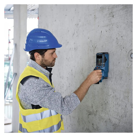 Man using Hardcore Stud Finder Wall Scanner Boasting Dead On Rebar And Wire Detection on concrete wall for DIY project.