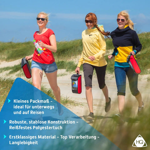 Three people walking on a windy beach carrying compact, colorful cases of Symphony Beach III 2.5 Stunt Kite Rainbow Dual Line Foil Sport Kite.