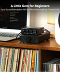 Q4 DAC Headphone Amp For PC And Home Audio Setup With USB Optical Coaxial Inputs, 3.5mm Headphone Output And RCA Speaker Outputs, Plug And Play Desktop Digital To Analog Converter For Richer Music, Gaming, And Movies. on a desk beside a laptop and speaker