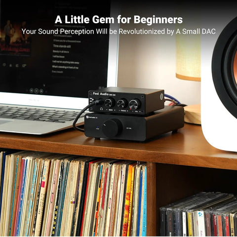 Q4 DAC Headphone Amp For PC And Home Audio Setup With USB Optical Coaxial Inputs, 3.5mm Headphone Output And RCA Speaker Outputs, Plug And Play Desktop Digital To Analog Converter For Richer Music, Gaming, And Movies. on a desk beside a laptop and speaker