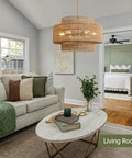 Large Handwoven Rattan Chandelier For Dining Room Boho Chic Pendant Light With Gold Plated Cylinder Rod Casting Dreamy Shadows in living room setting.