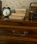 Close-up of drawer with Vintage Drop Bail Drawer Pulls Set In Antique Brass 6 Pack For Furniture Restoration And Dresser Updates