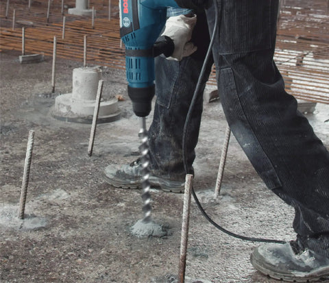 Worker using 7/8 Inch by 21 Inch SDS-Max Speed-X Carbide Rotary Hammer Bit for Concrete Drilling Fits All SDS-Max and TE Shanks
