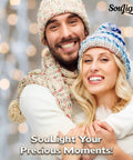 Happy couple in winter hats and scarves smiling with bokeh lights background. SouLight Your Precious Moments text overlay.