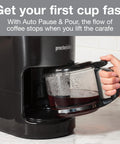 Person holding a borosilicate glass carafe in black 10-Cup Coffee Maker With Auto Pause And Serve, Works With Alexa-Enabled Smart Plugs