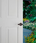 Ashfield Entry Door Handle With Lock And Key For Front Doors And Bedrooms in Venetian Bronze Finish on white door