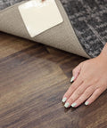 Non Slip Corner Gripper Rug Tabs Eight Pack Anti Curling Double Sided Adhesive 4 Inch By 4 Inch Squares in use on rug corner