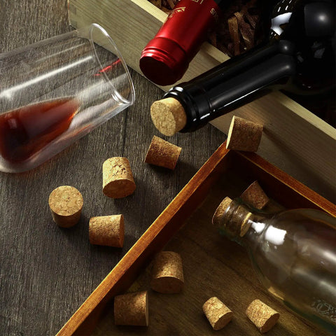 Close-up of wine bottles and glasses with 120 Piece 8 Sizes Tapered Cork Stoppers Set Natural Wood Wine Bottle Plugs.