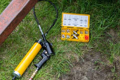 LockNLube grease fitting replacement kit in a yellow organizer case with SAE and metric zerks