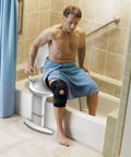 Man using Tub Transfer Bench Shower Chair For Elderly And Disabled Adjustable Height From 16 To 21 Inches in bathtub