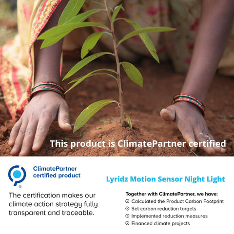 Hands planting tree sapling, promoting ClimatePartner certified Lyridz Motion Sensor Night Light initiative for environmental impact.