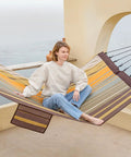 Person relaxing on 14 Foot Two Person Outdoor Hammock With Quick Dry Textilene Fabric, Portable No Stand Needed, folding steel spreader bar