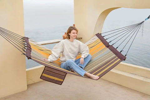 Person relaxing on 14 Foot Two Person Outdoor Hammock With Quick Dry Textilene Fabric, Portable No Stand Needed, folding steel spreader bar