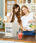 Cream Countertop Nugget Ice Maker With Visible Window And Sleek Touchscreen pouring drinks in kitchen with friends.